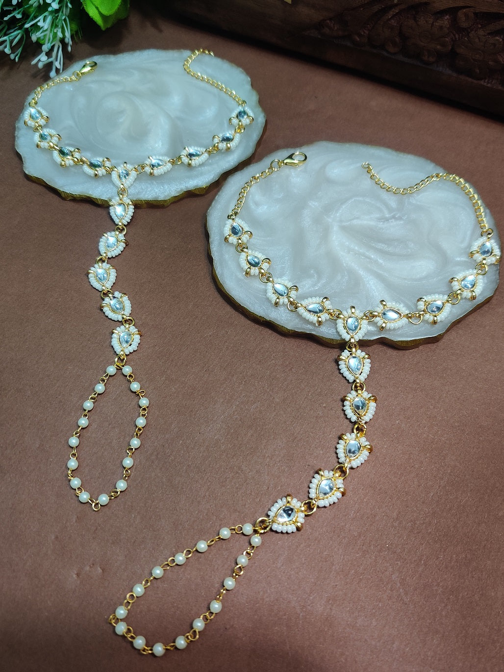 Set Of 2 Gold-Plated Kundan Studded Finger Ring Hathphool Pearl Bracelets